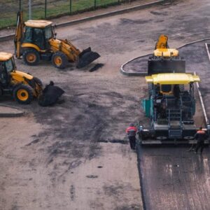 Heavy machinery laying asphalt during parking lot construction in California with ADA compliance in mind